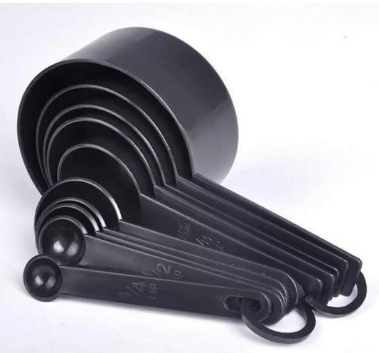 Black measuring cups and spoons stacked together for compact storage