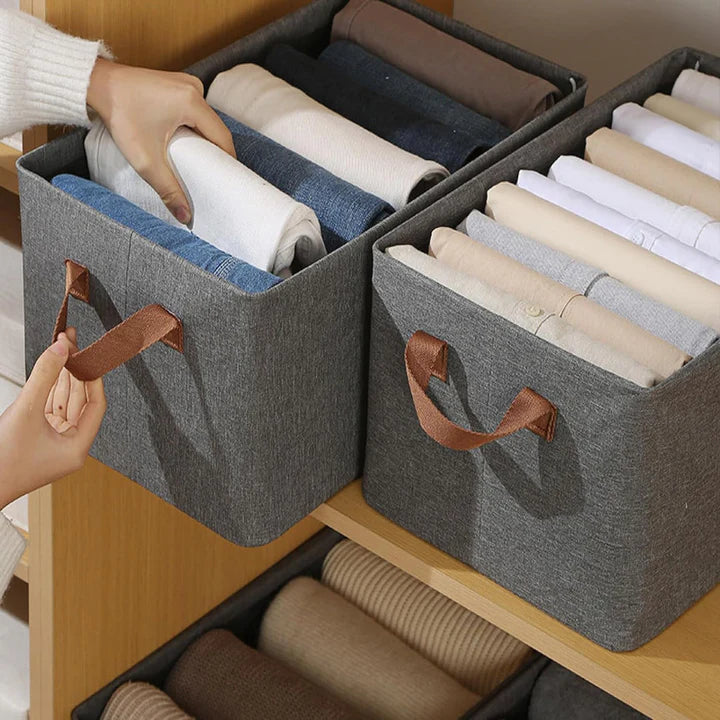 Foldable wardrobe storage boxes with handles organizing clothes on shelves