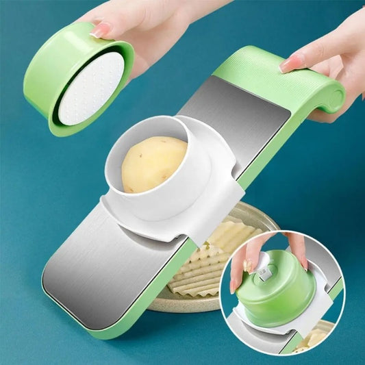 Vegetable slicer and grater slicing a potato with hand guard