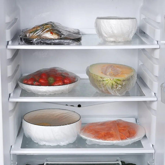 Elastic food covers used on bowls and plates inside a refrigerator