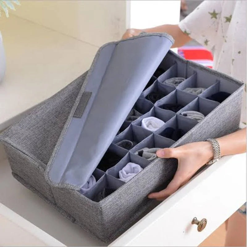 24-cell lidded organizer being placed inside a drawer for clothing storage