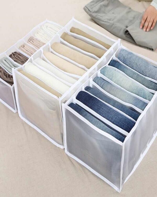 Wardrobe organizers separating jeans, trousers and folded clothes into compartments