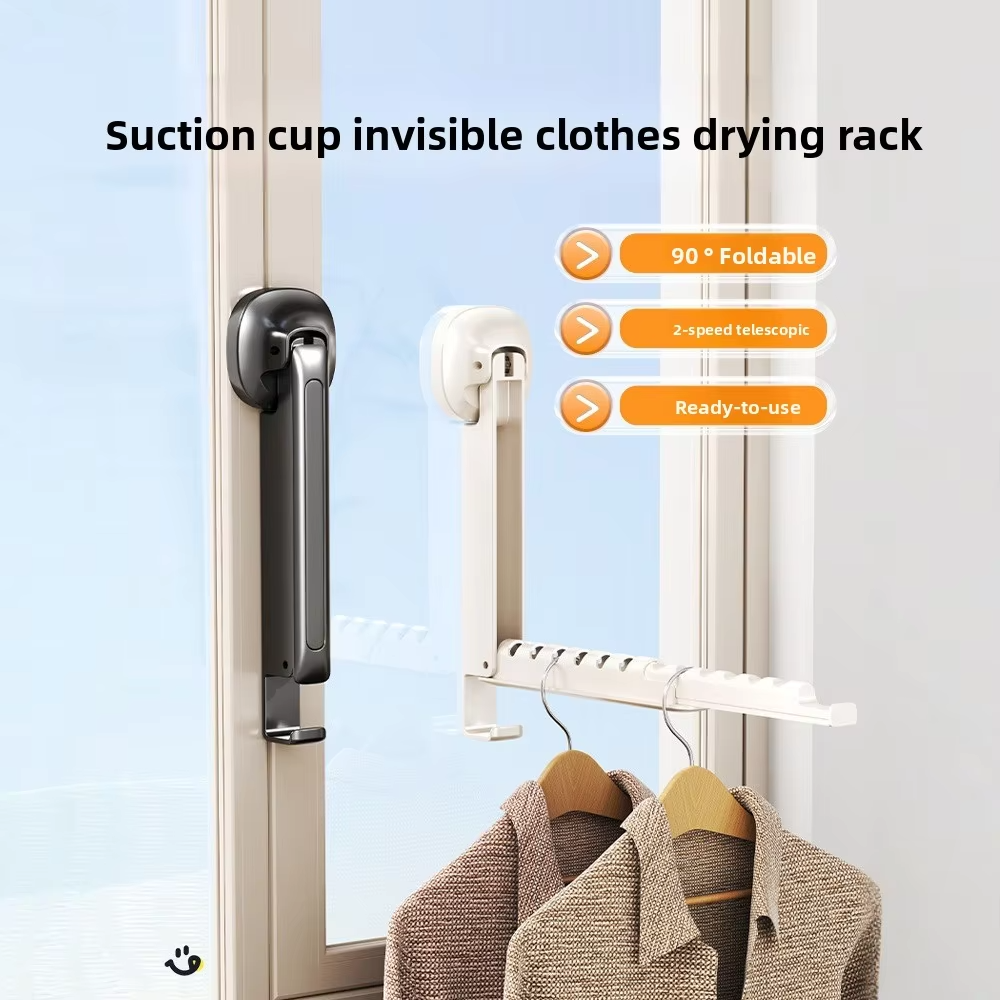 Foldable suction-cup clothes drying rack mounted by a window with clothes hanging