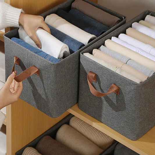 Foldable wardrobe storage boxes with handles organizing clothes on shelves