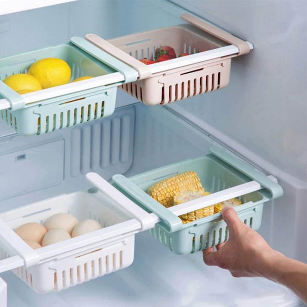 Adjustable hanging fridge basket holding eggs and corn beneath refrigerator shelves