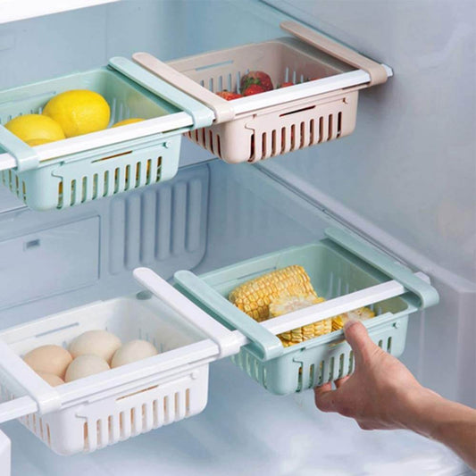 Adjustable hanging fridge basket holding eggs and corn beneath refrigerator shelves