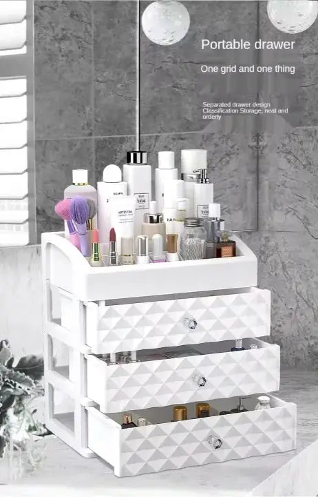 White three-drawer organizer with cosmetic products and open storage drawers