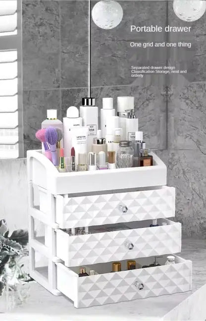 White three-drawer organizer with cosmetic products and open storage drawers