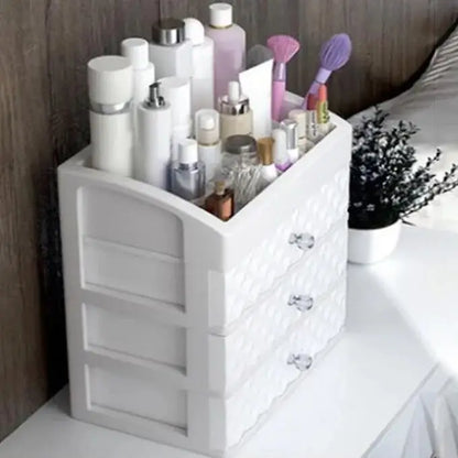 Side view of white three-drawer cosmetic organizer with top storage compartment
