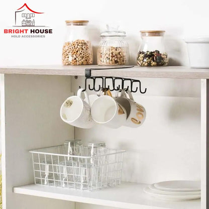 Black under-shelf mug holder rack with mugs hanging in a kitchen cabinet