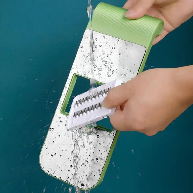 Vegetable slicer and grater being rinsed and cleaned