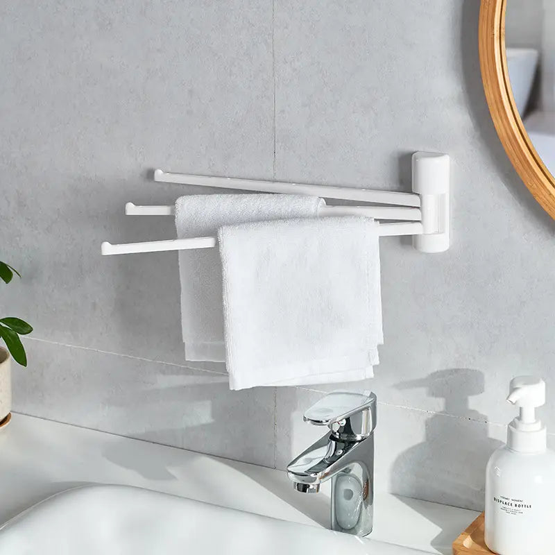 White wall-mounted rotating towel rack with three arms in bathroom