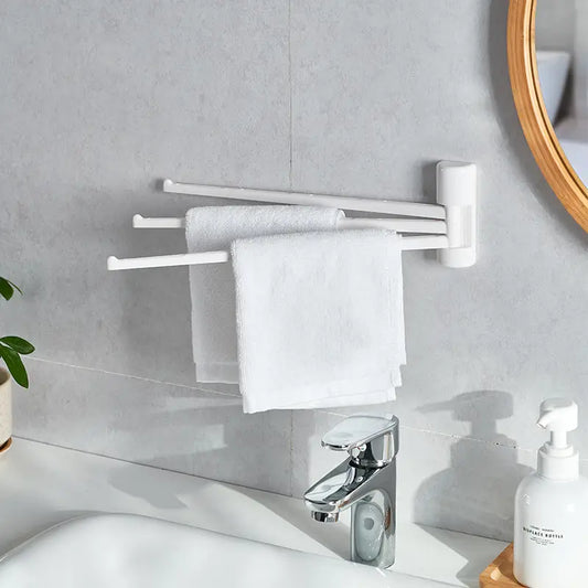 White wall-mounted rotating towel rack with three arms in bathroom